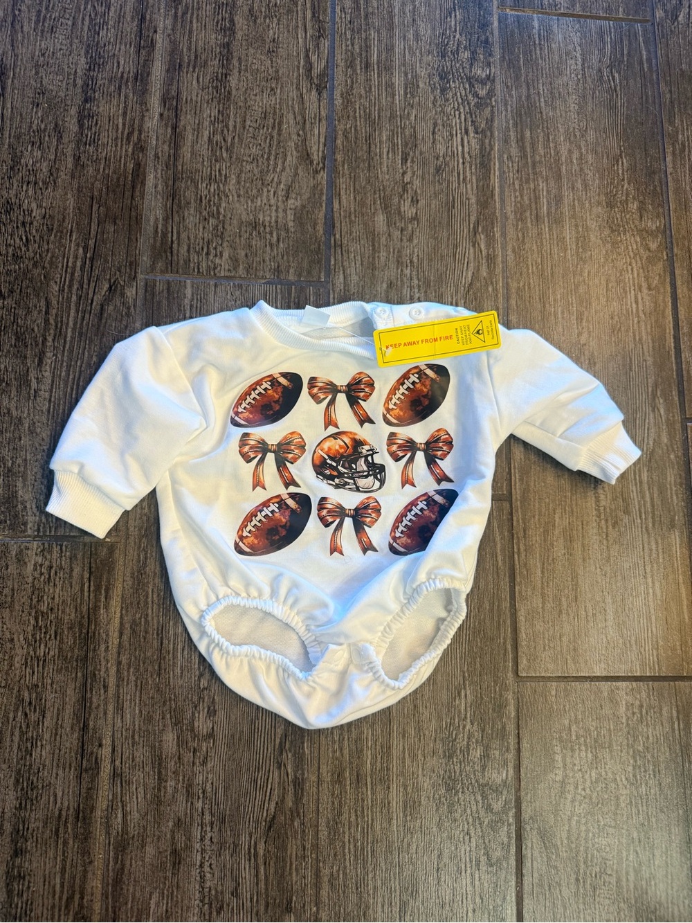 NWT football and bows onsie.